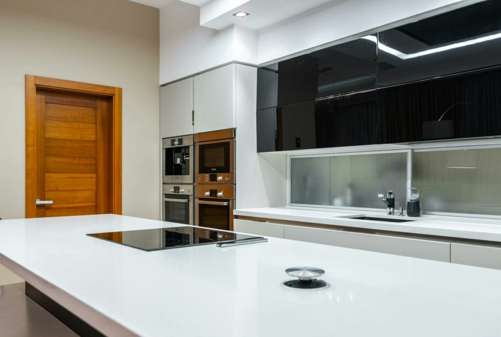 Interior of modern spacious kitchen area with minimalistic style placed in contemporary apartment